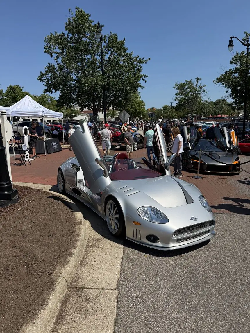 A Spyker C8 with its doors raised at the monthly Exotic Car Show